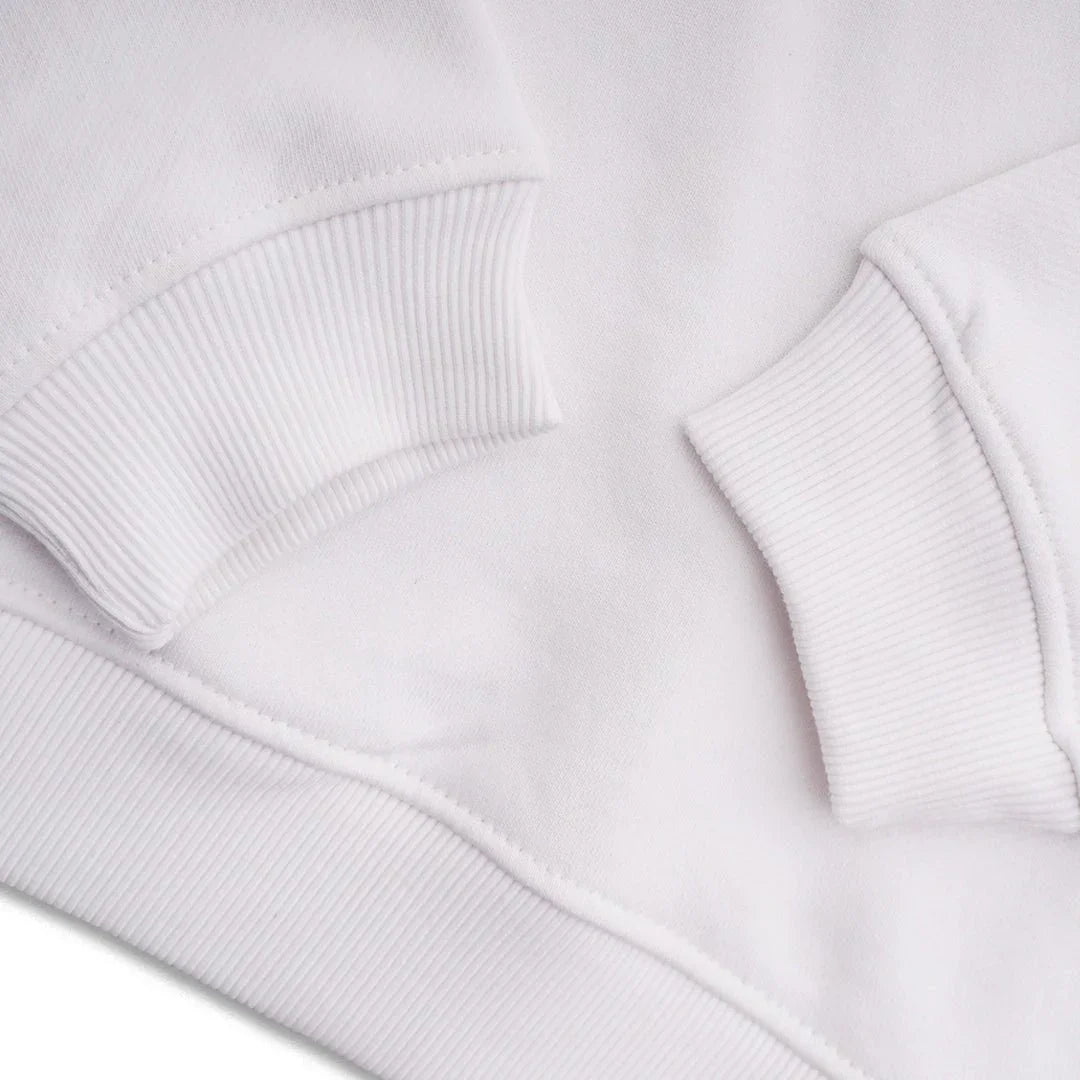Close-up of white sweatshirt with ribbed cuffs and hem, soft cotton fabric detail