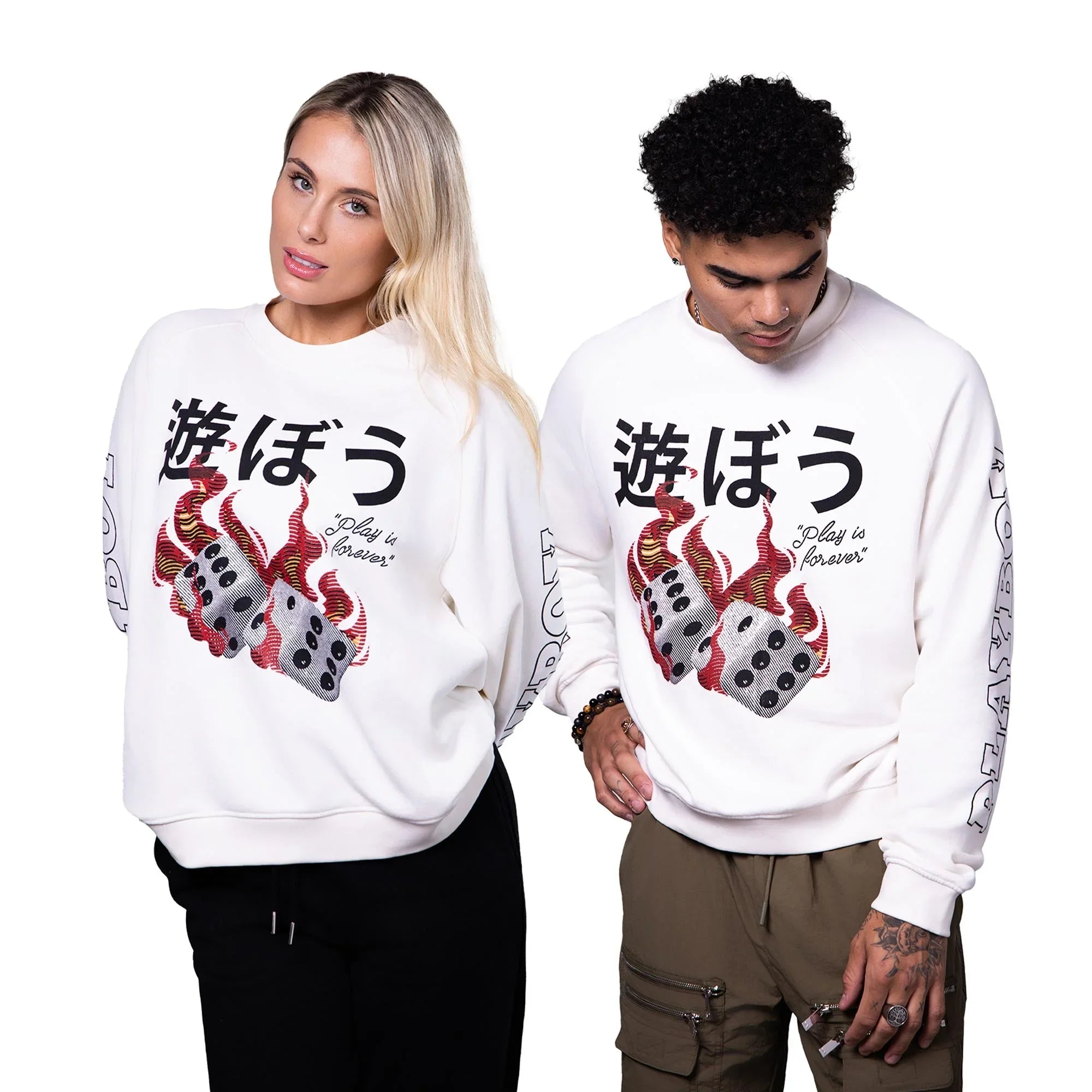 Two models wearing white graphic sweatshirts with flaming dice, bold Japanese text, and sleeve lettering
