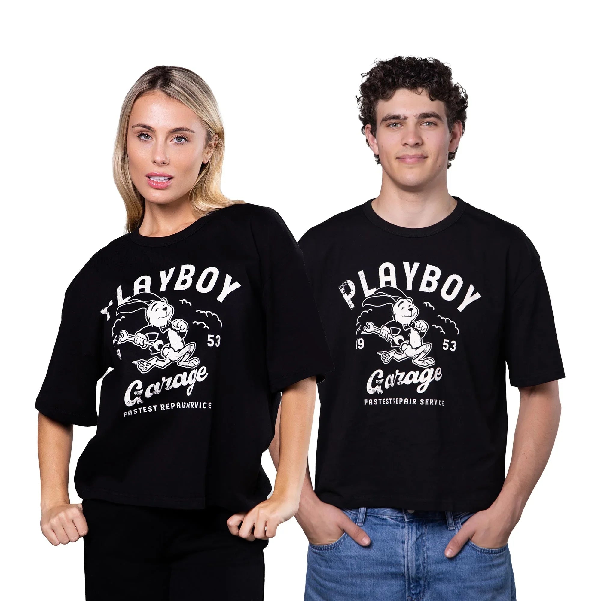Two models wearing black graphic boxy tees with bold vintage 'Playboy Garage' print design.
