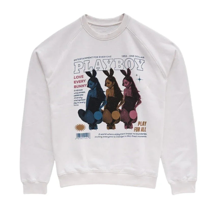 White crewneck sweatshirt featuring colorful graphic of three bunny-costumed women and bold text.