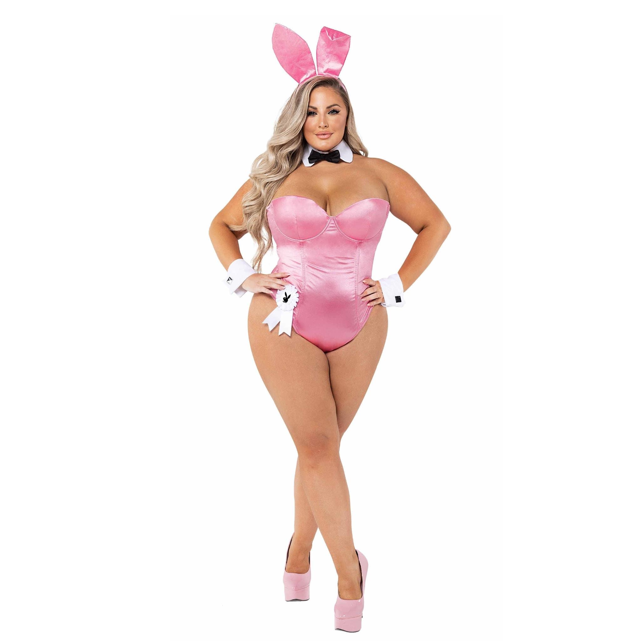 Woman in pink bunny costume with headband ears, bodysuit, cuffs, bow tie, and high heels