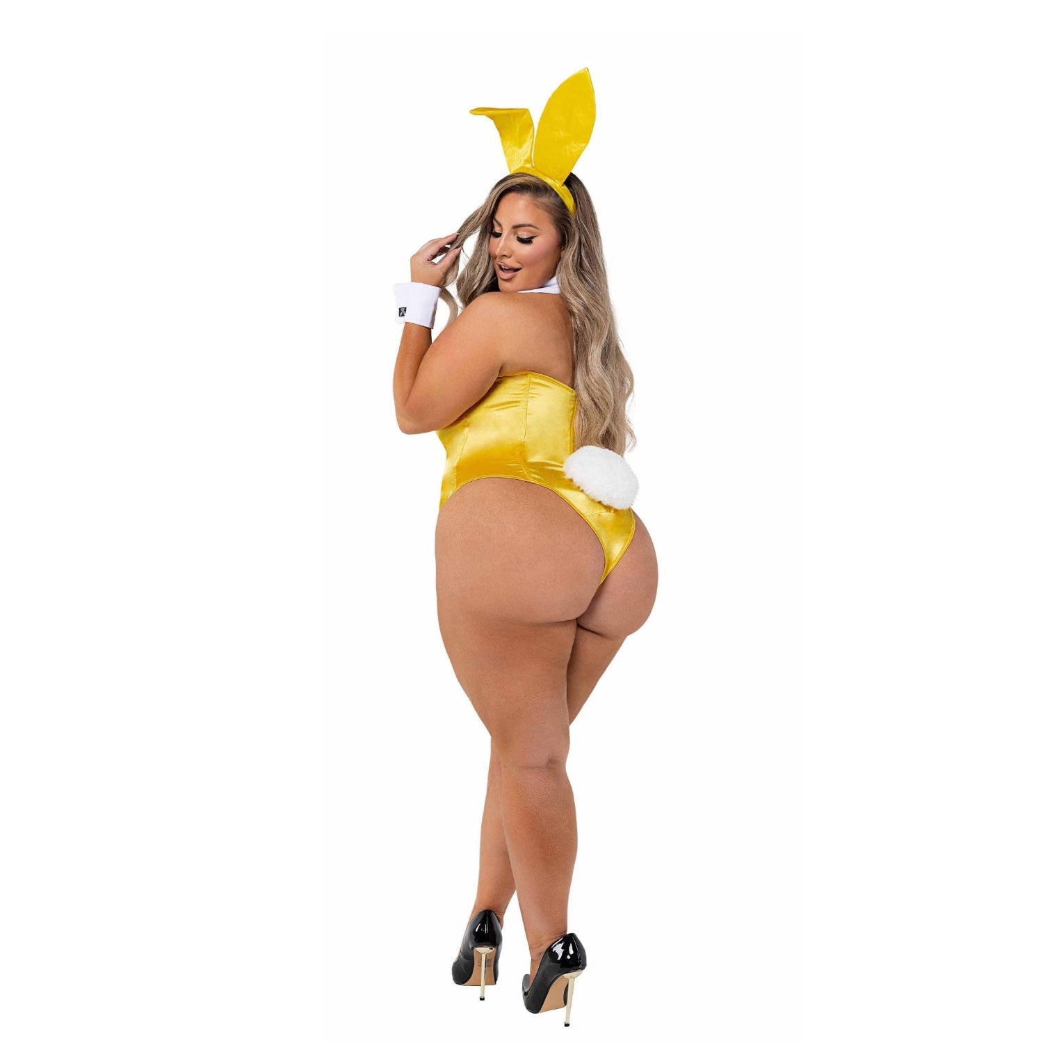 Woman wearing a yellow bunny costume with ears, white cuffs, and black heels on white background