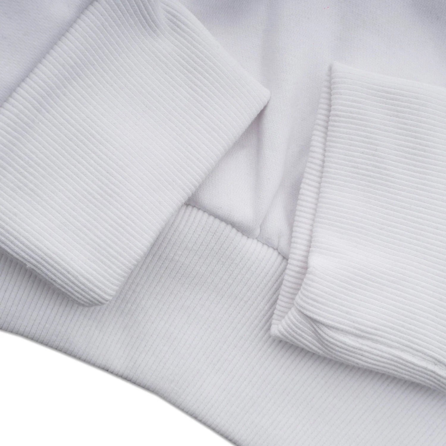 close-up of white ribbed chenille hoodie sleeve and hem, soft texture clothing detail