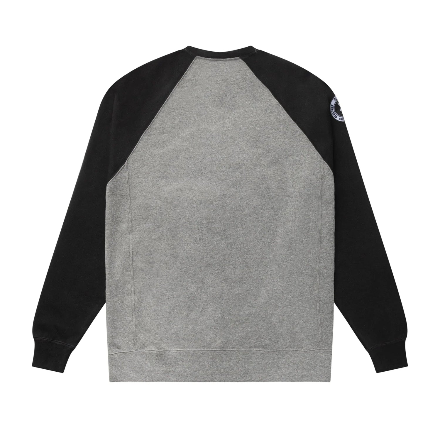 Back view of grey crewneck sweatshirt with black raglan sleeves and patch on right shoulder.