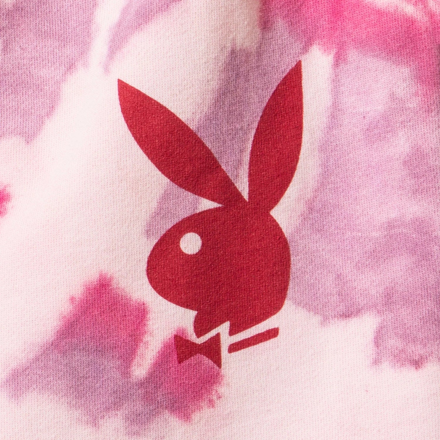 Pink tie-dye shorts with a red bunny logo print on soft fabric