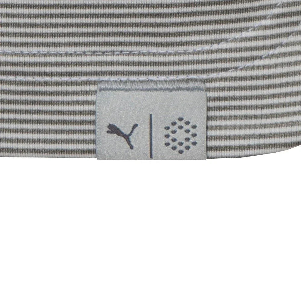 Close-up of a gray and white striped polo shirt hem with small fabric tag and stitched details