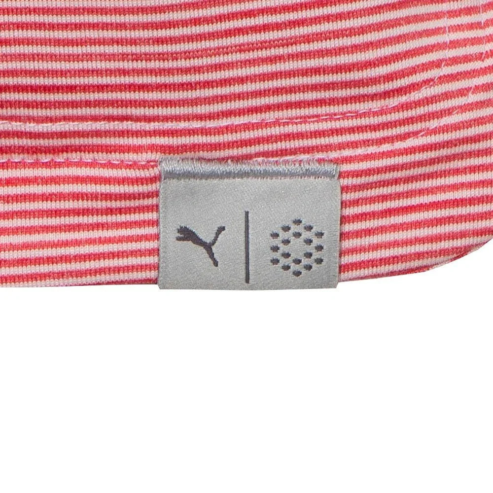 Close-up of pink and white striped golf polo shirt hem with fabric tag