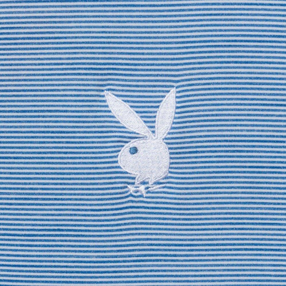 White bunny logo embroidered on light blue and white striped polo shirt fabric