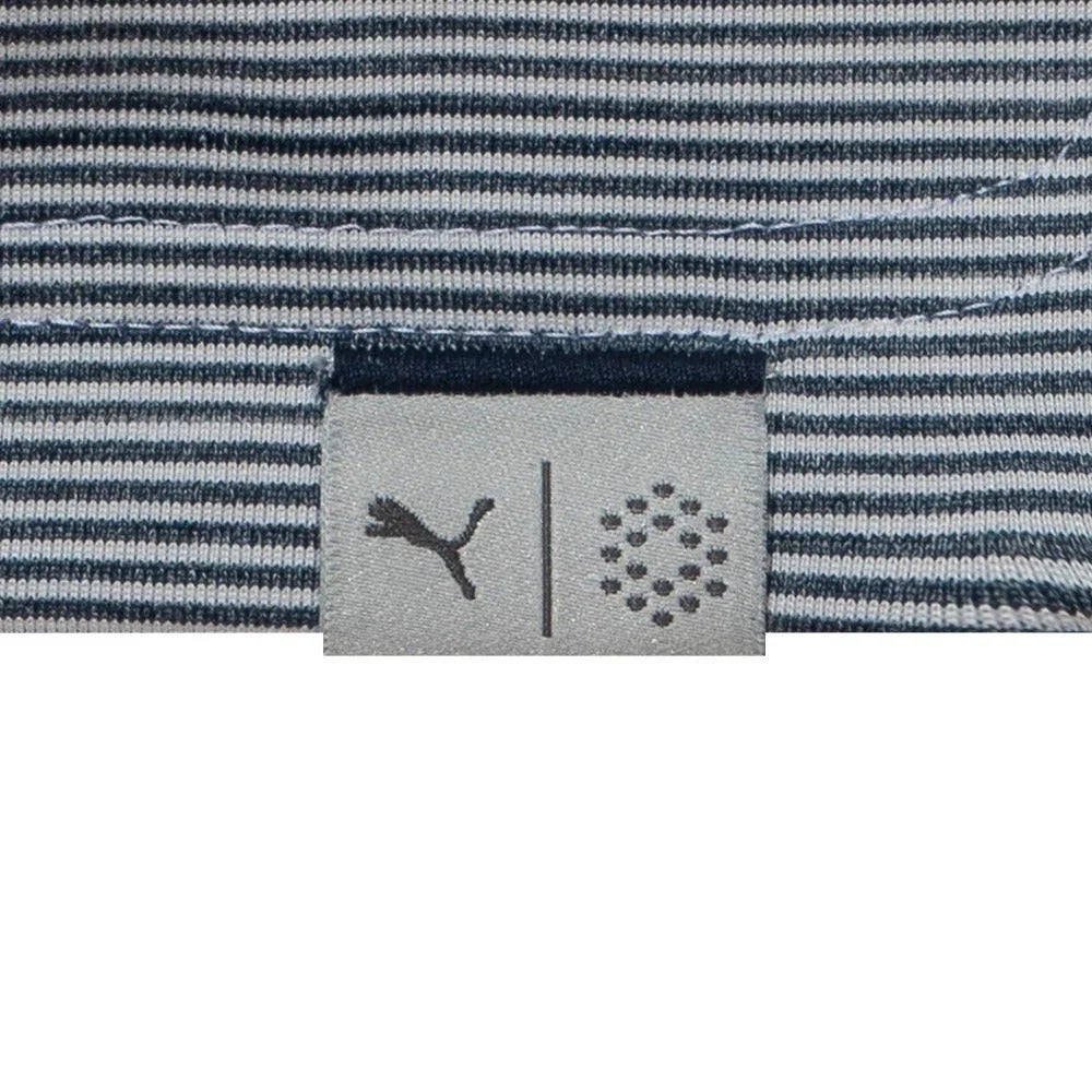 Close-up of blue and white striped golf polo shirt hem with two logos on tag