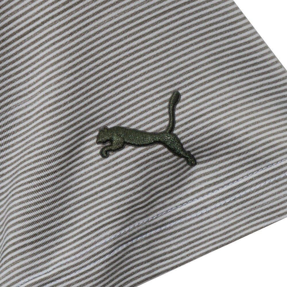 Closeup of a grey and white striped polo shirt with a green puma logo patch