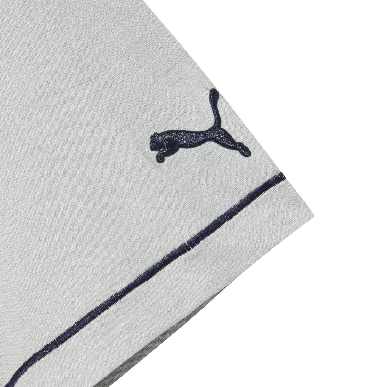 Close-up of grey polo shirt sleeve with black puma logo and dark stripe trim