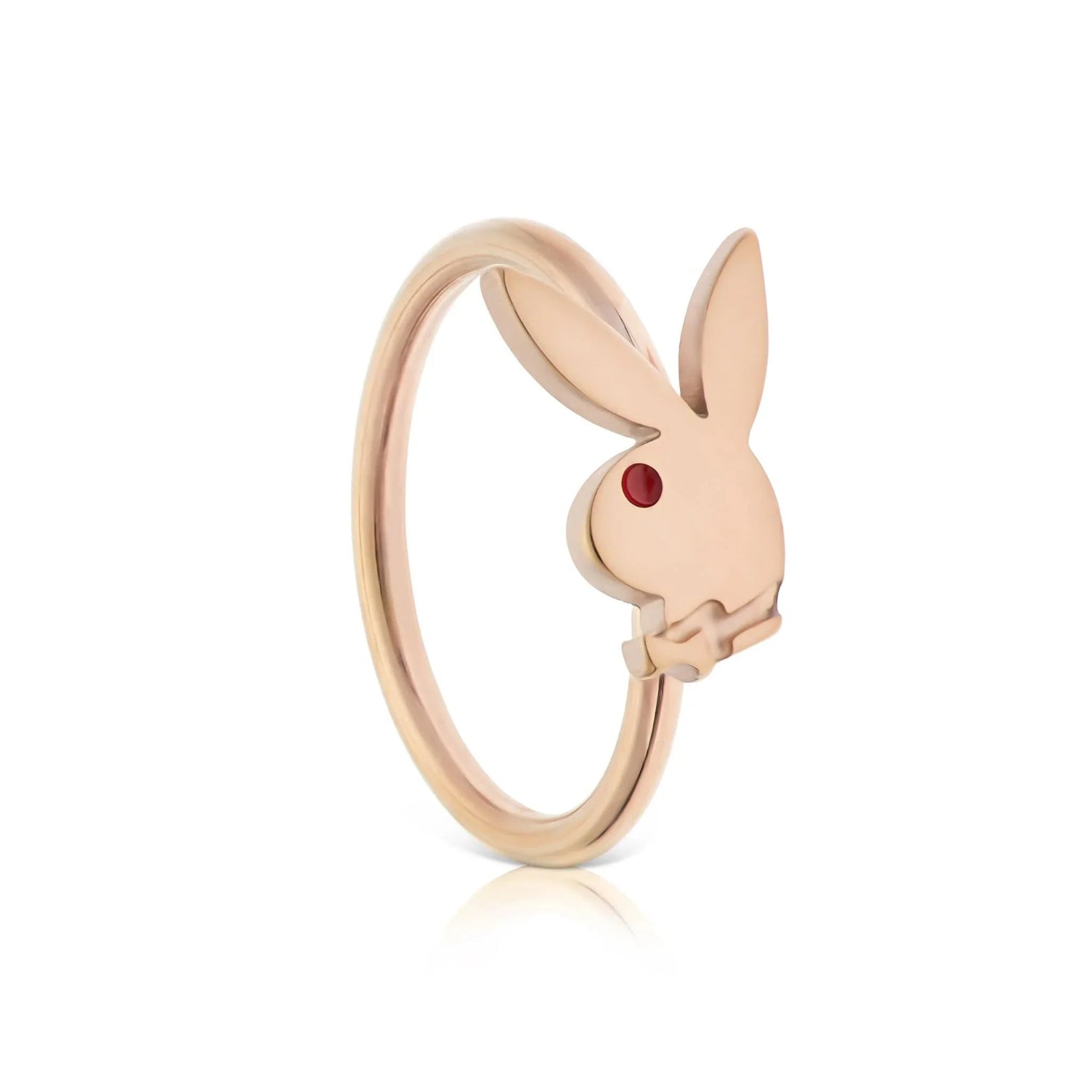 Gold nose ring with a rabbit head charm and red gemstone eye on a white background