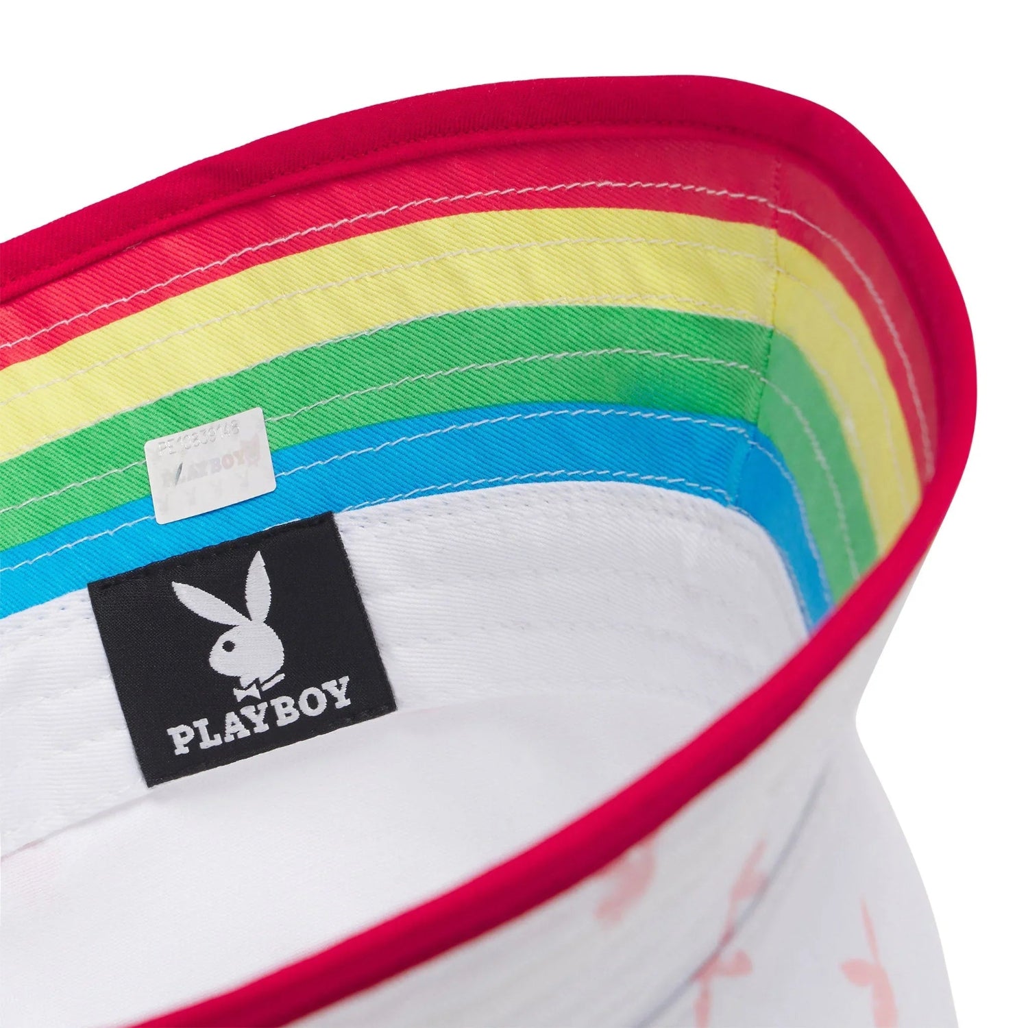 Close-up of white bucket hat with rainbow lining and rabbit logo tag