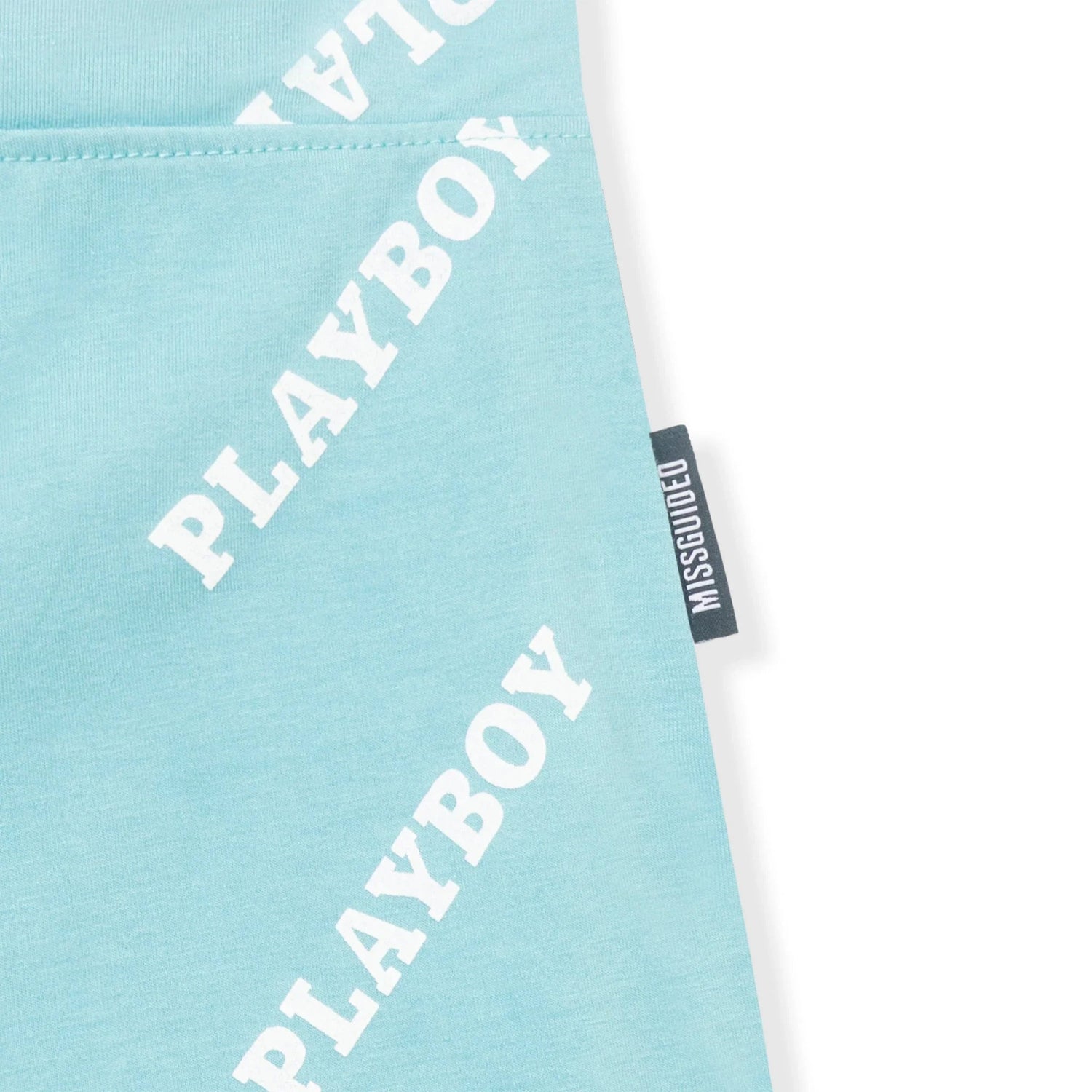 Light blue bike shorts with white diagonal PLAYBOY text and Missguided side tag