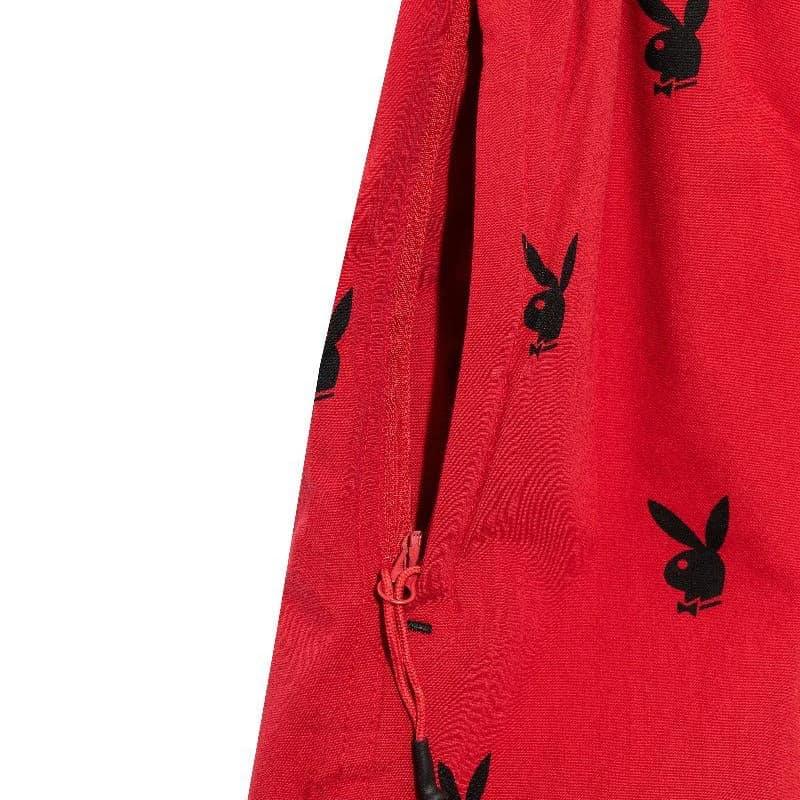 Red lounge shorts with repeating black rabbit head pattern and side drawstring detail