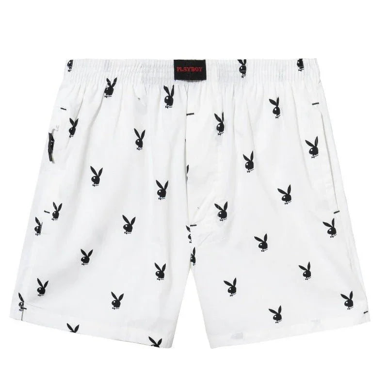 White lounge shorts with repeating black rabbit head print, elastic waistband, front pockets
