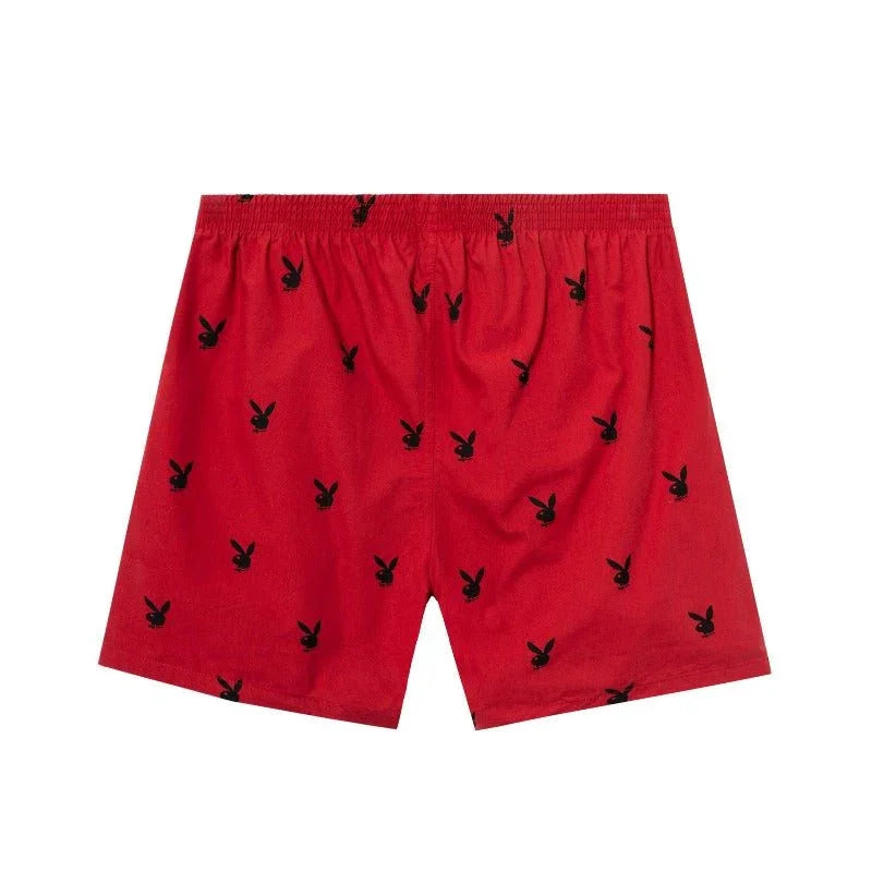 Red lounge shorts with all-over black rabbit head pattern and elastic waistband