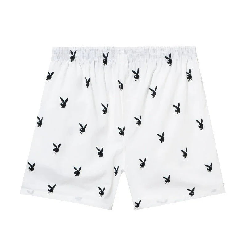 White lounge shorts with black repeating rabbit head pattern, elastic waistband, casual fit