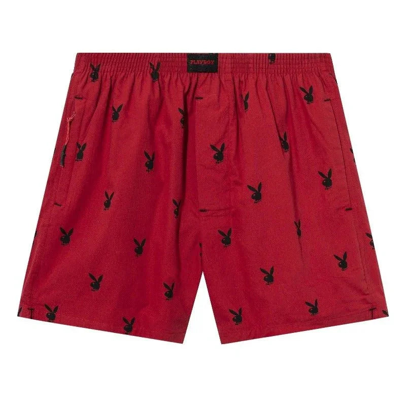 Red lounge shorts with all-over black rabbit head print, elastic waistband, relaxed fit.