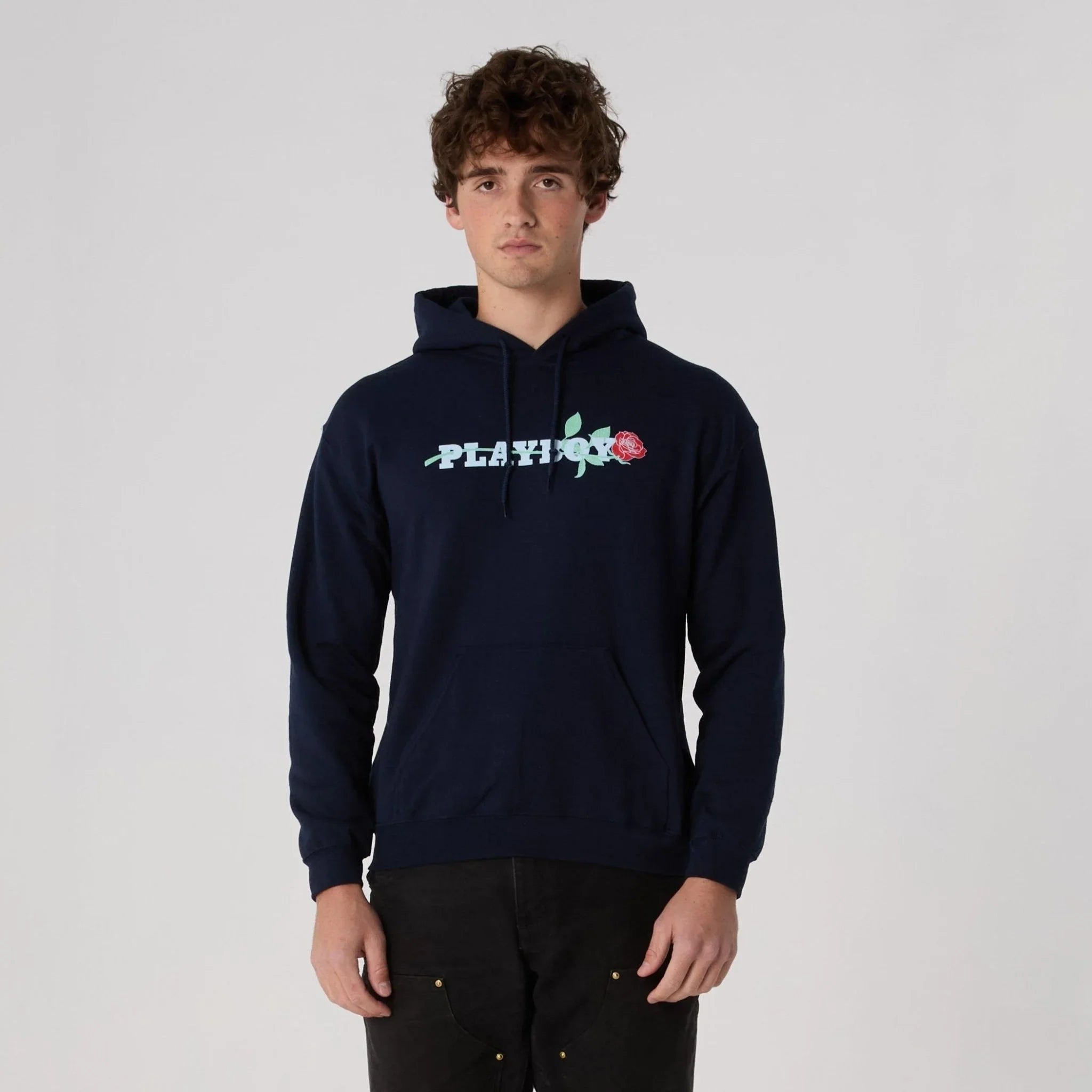 Navy blue hoodie with floral logo graphic and rose graphic, modeled by man.
