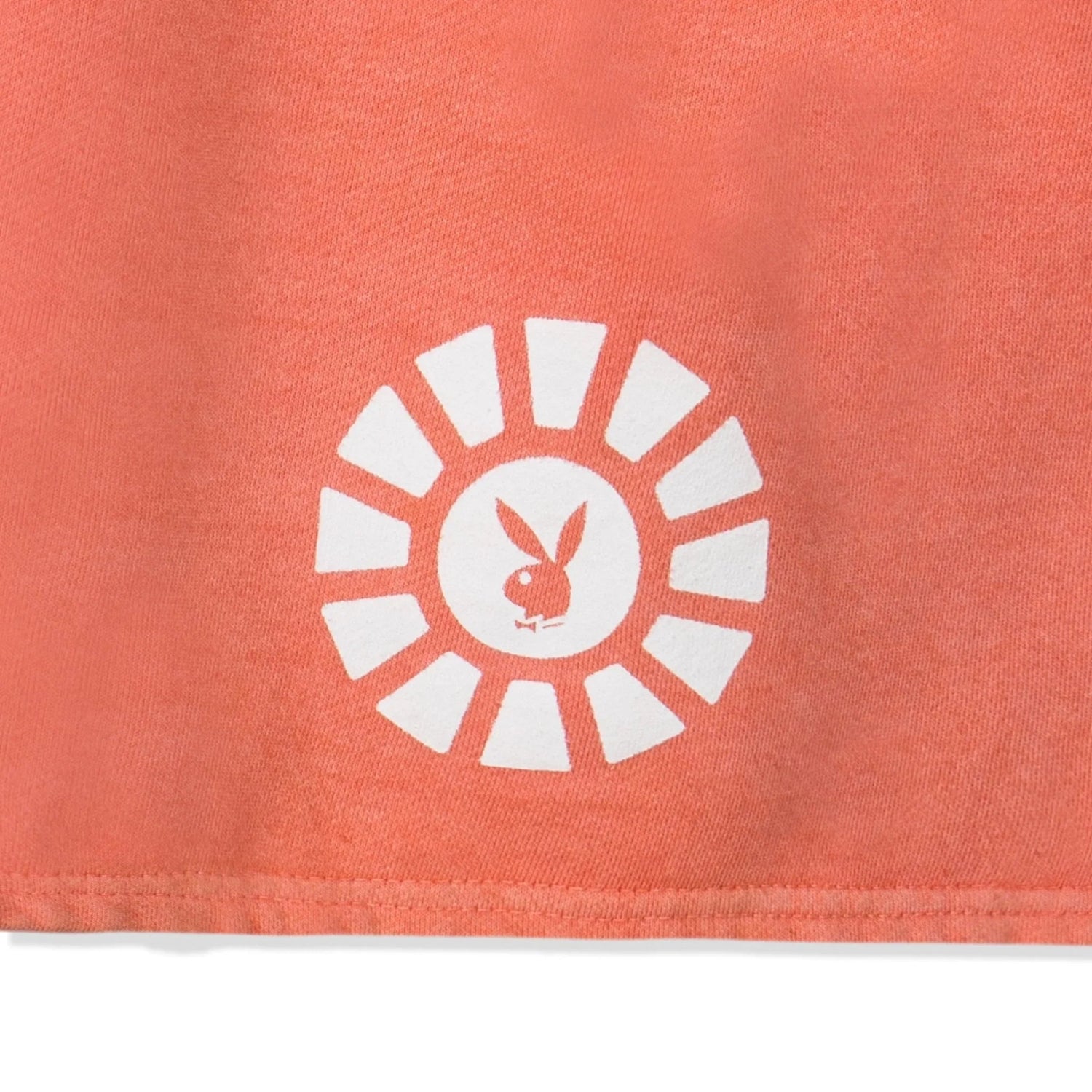 Coral sweatshorts with white sunburst graphic and bunny logo print detail