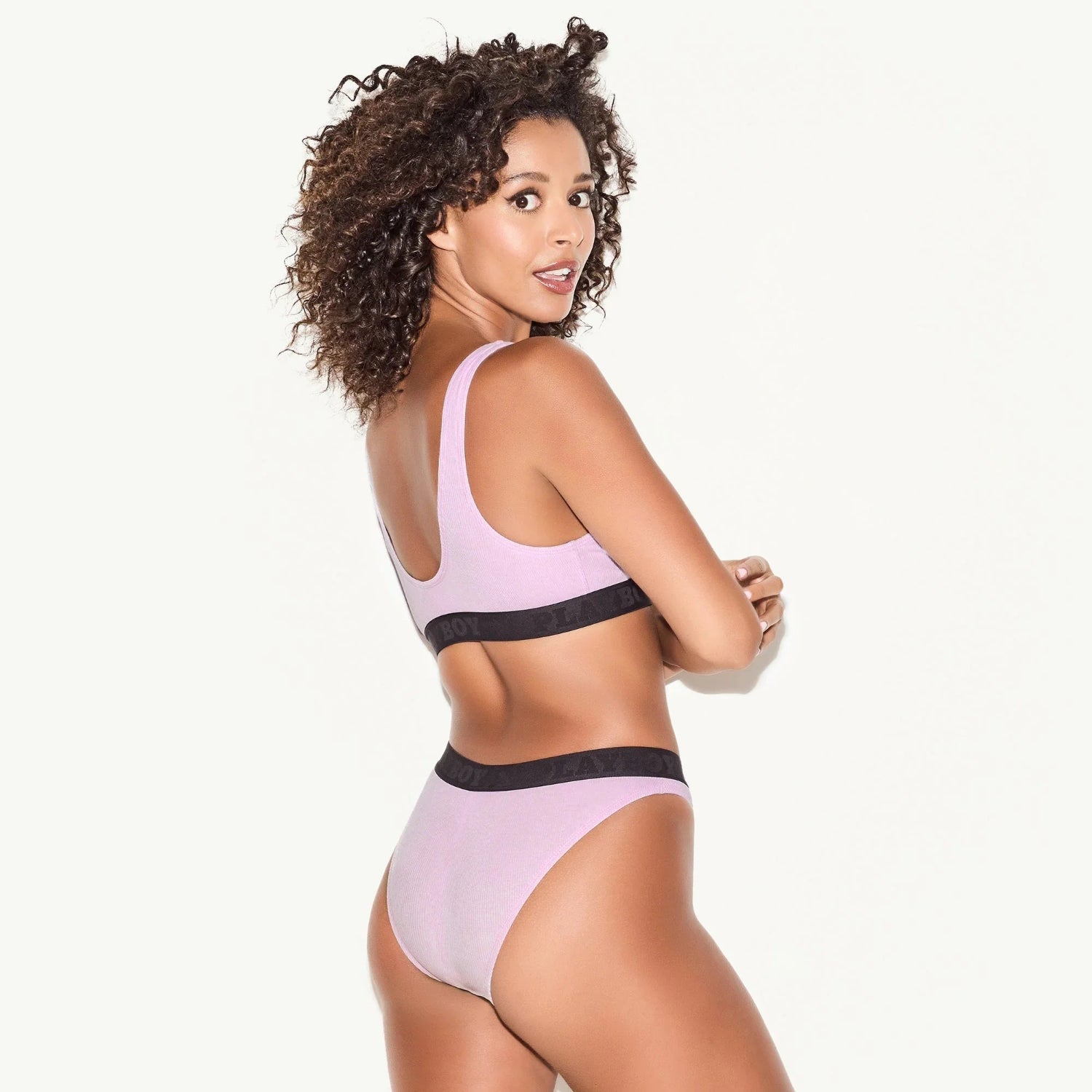 Woman wearing a lilac ribbed scoop neck bra and matching high-waisted brief underwear set