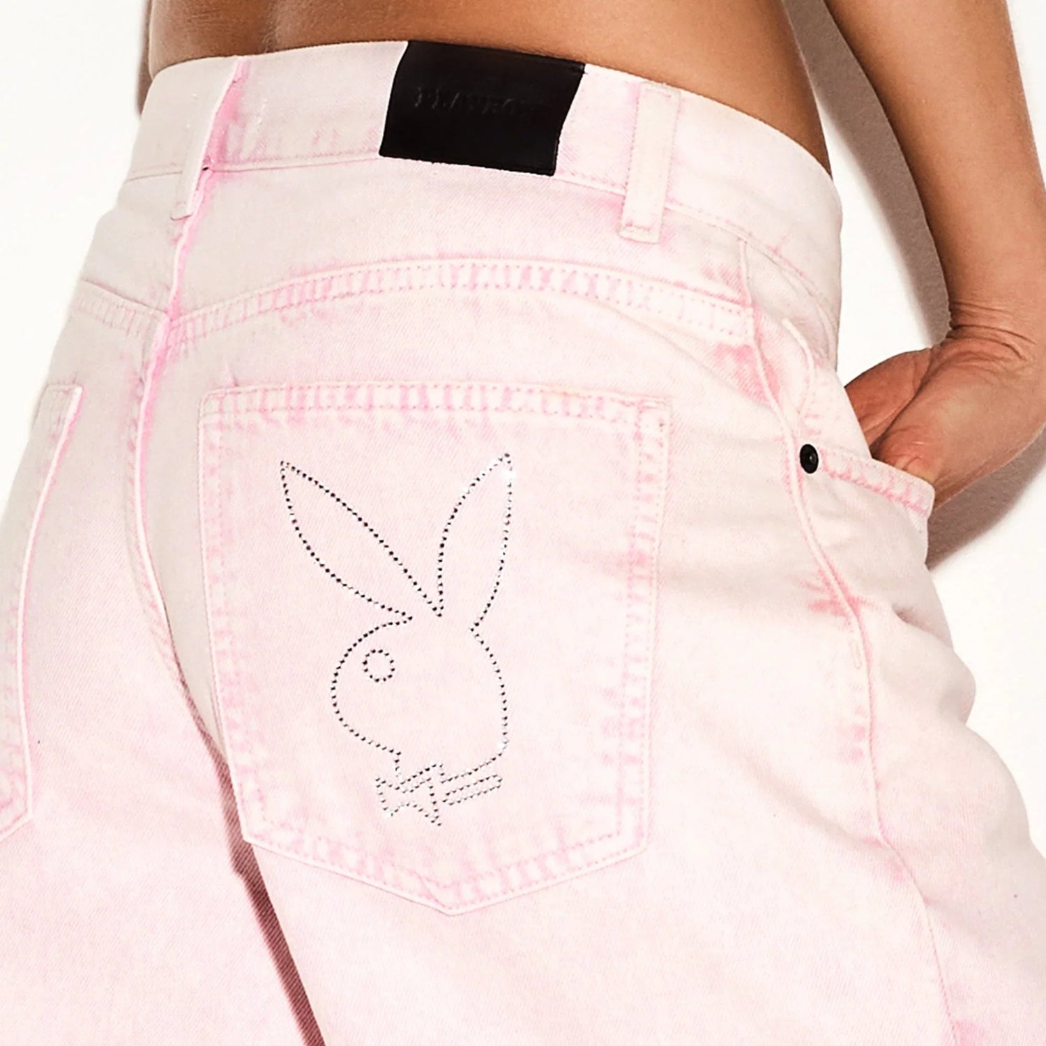 Low-rise pink stone wash skater jeans with bunny logo on back pocket