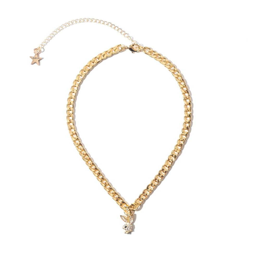 Gold chain necklace with a crystal bunny head pendant and star charm on white background