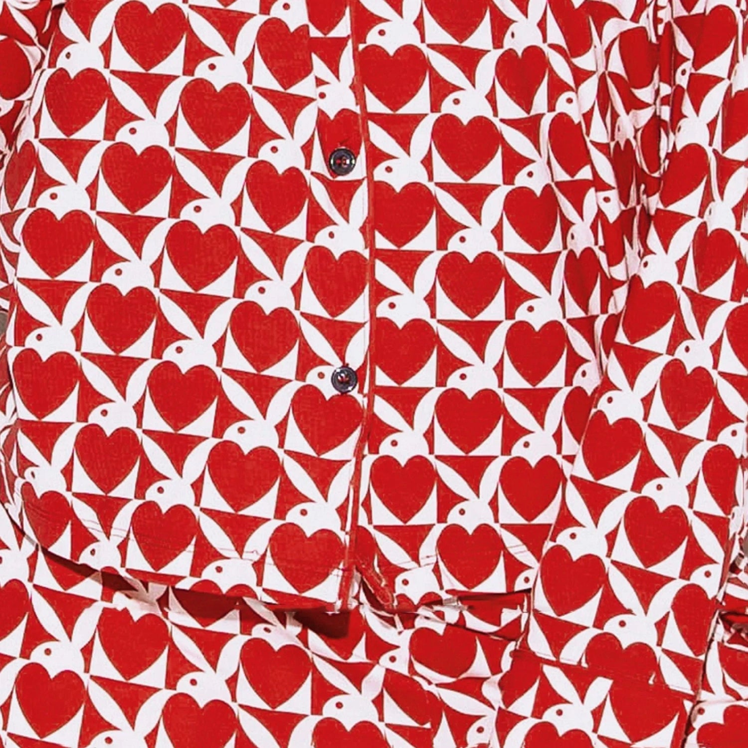 Red and white pajama set with heart and bunny ear pattern, close-up of buttoned shirt and pants