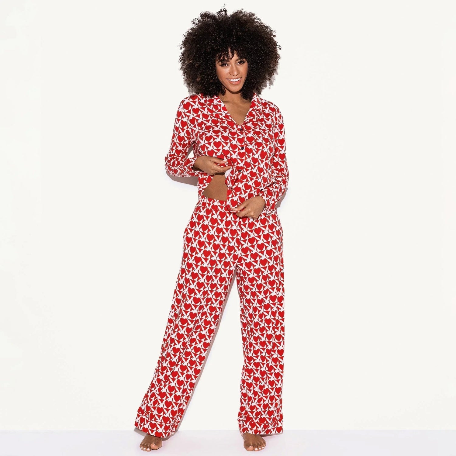 Woman wearing red and white patterned pajama set with long sleeves and pants