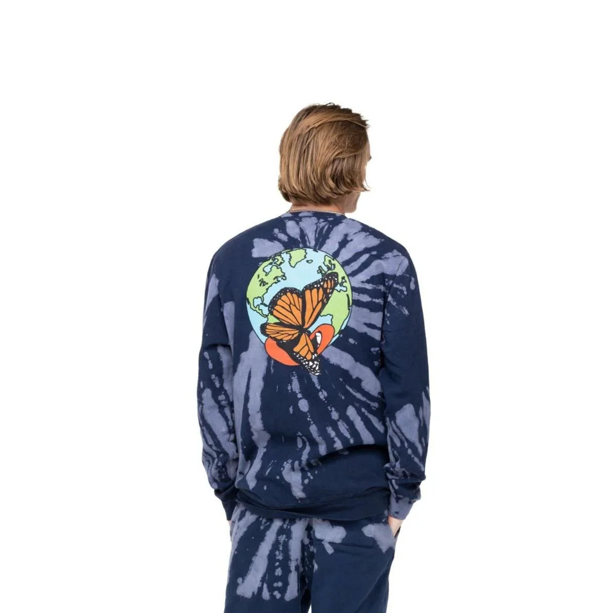 Man wearing navy blue tie-dye sweatshirt with large butterfly and earth graphic on back