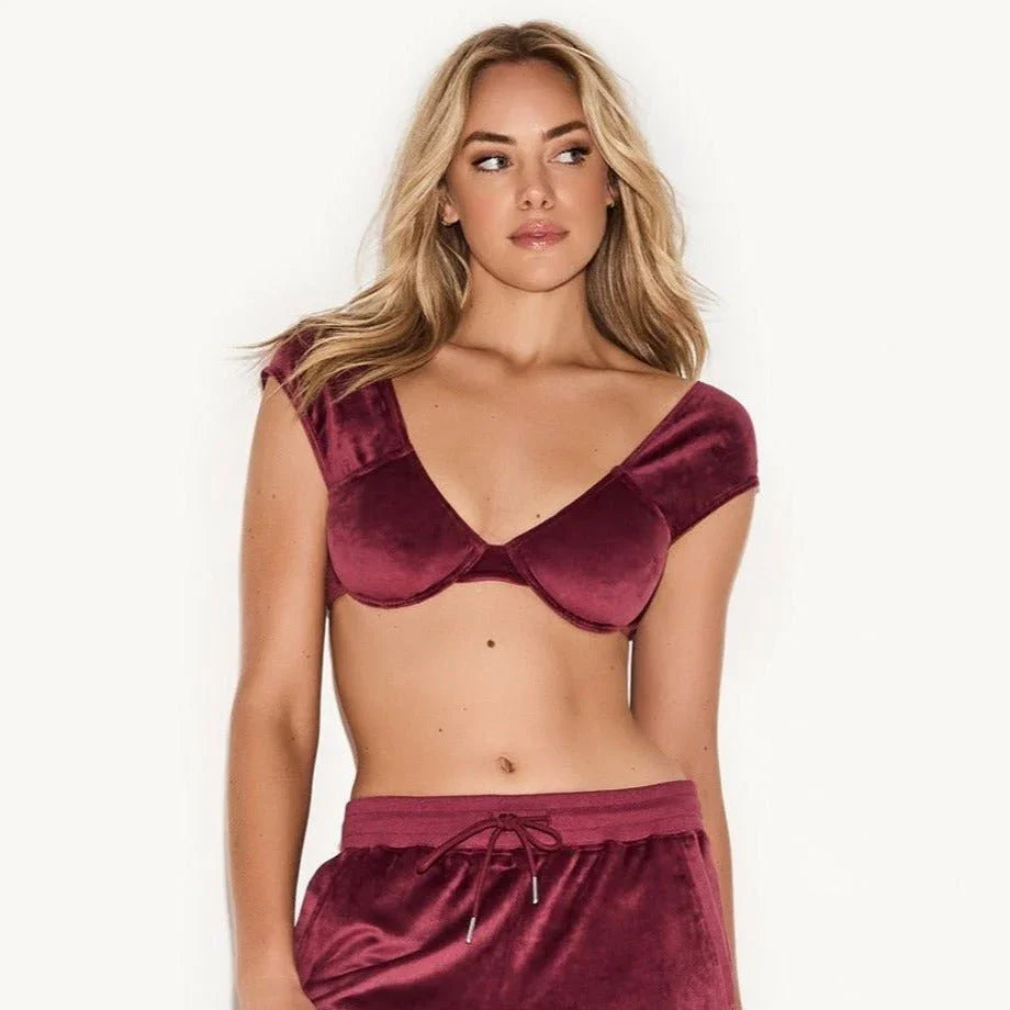 Woman modeling burgundy velour underwire cap sleeve bra and matching lounge shorts.