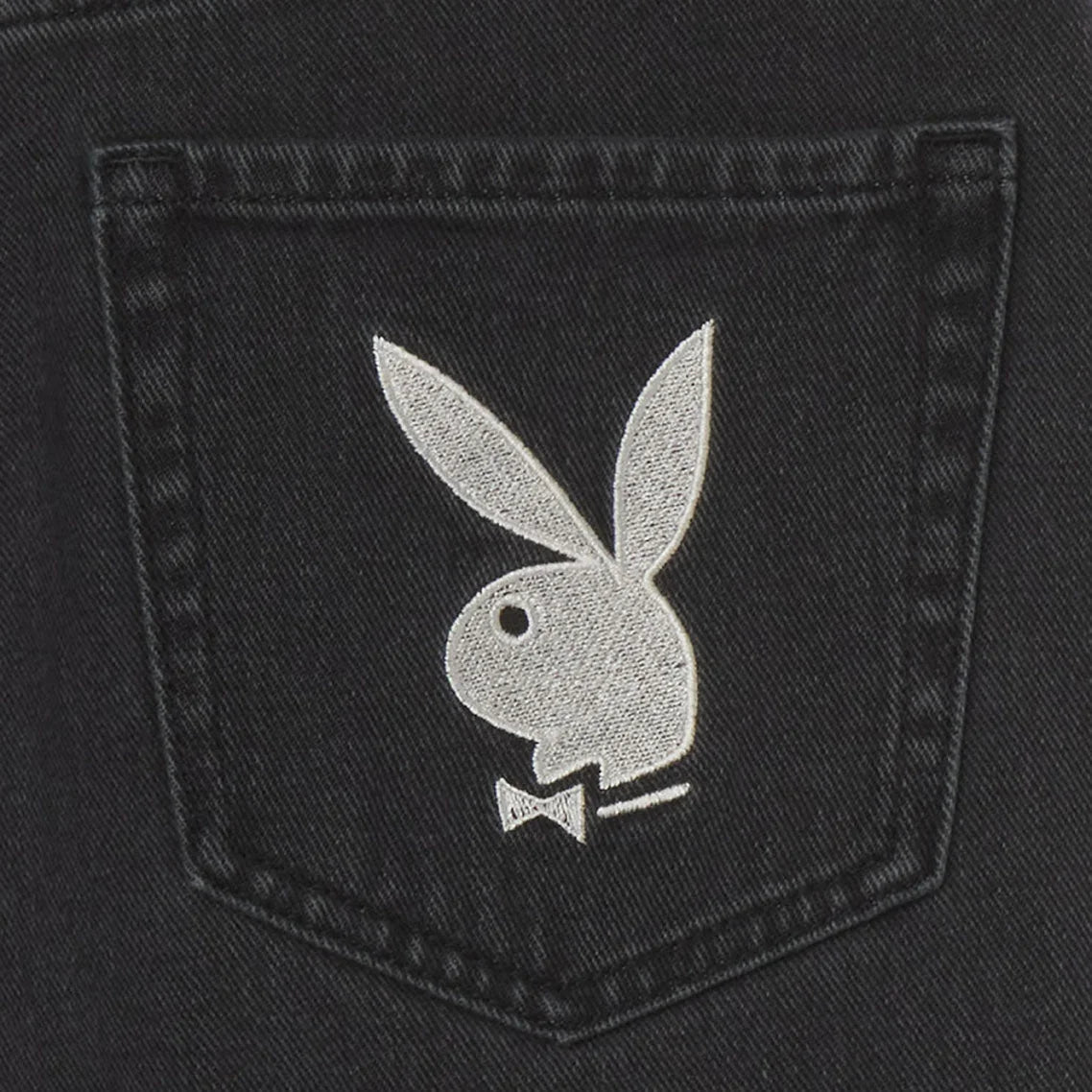Close-up of black denim pocket with white bunny head embroidery, women's 90s boyfriend jeans.
