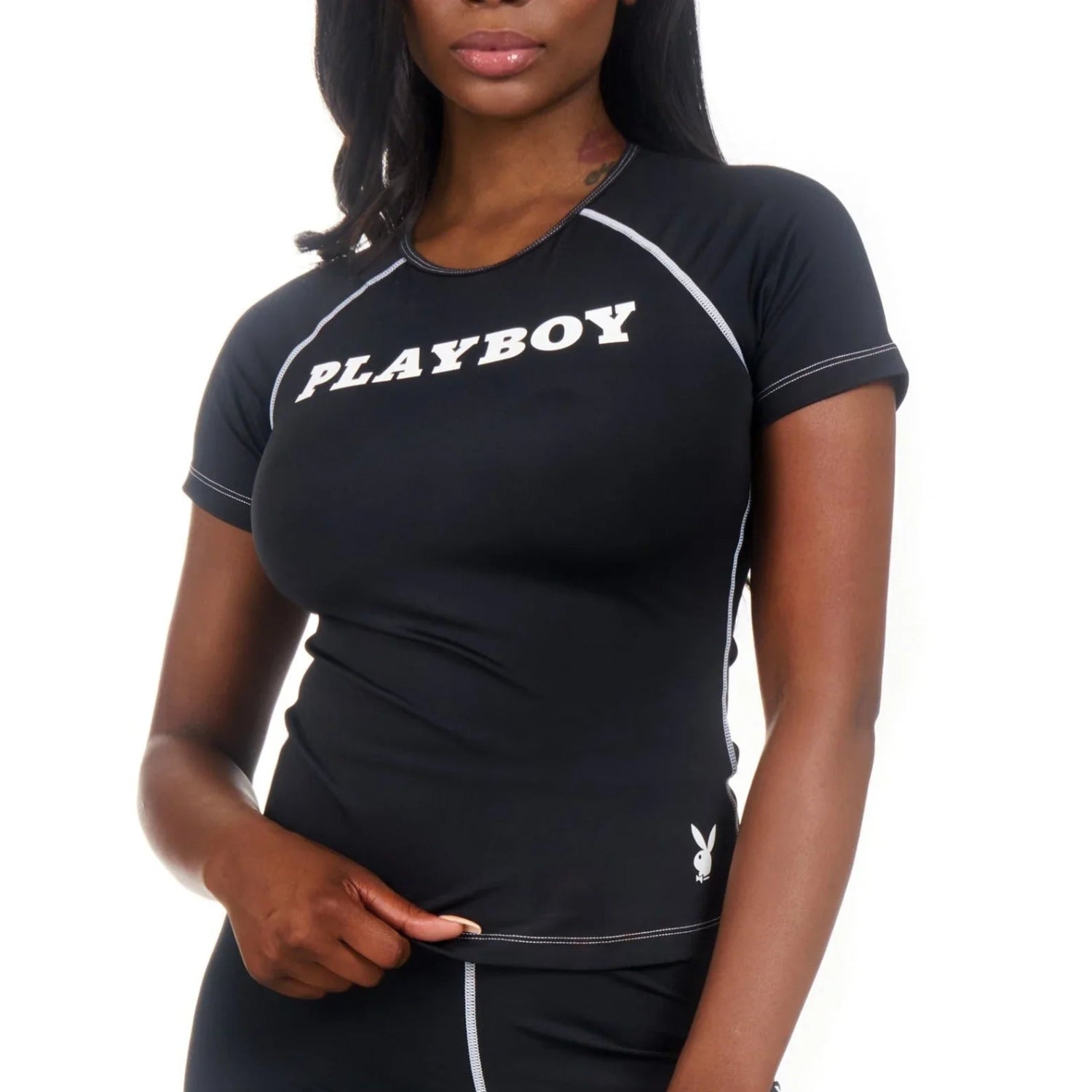 Woman wearing black active contrast stitch tee with PLAYBOY logo and white piping details