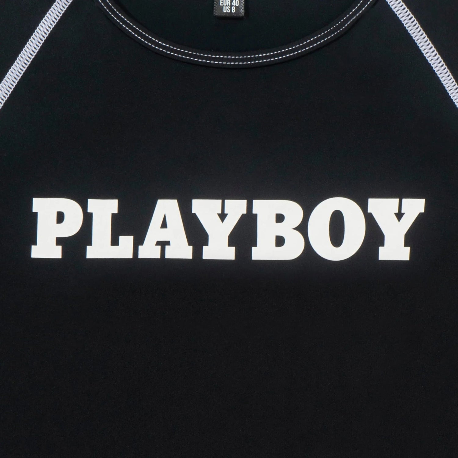 Black women's active tee with bold PLAYBOY logo and white contrast stitching detail.