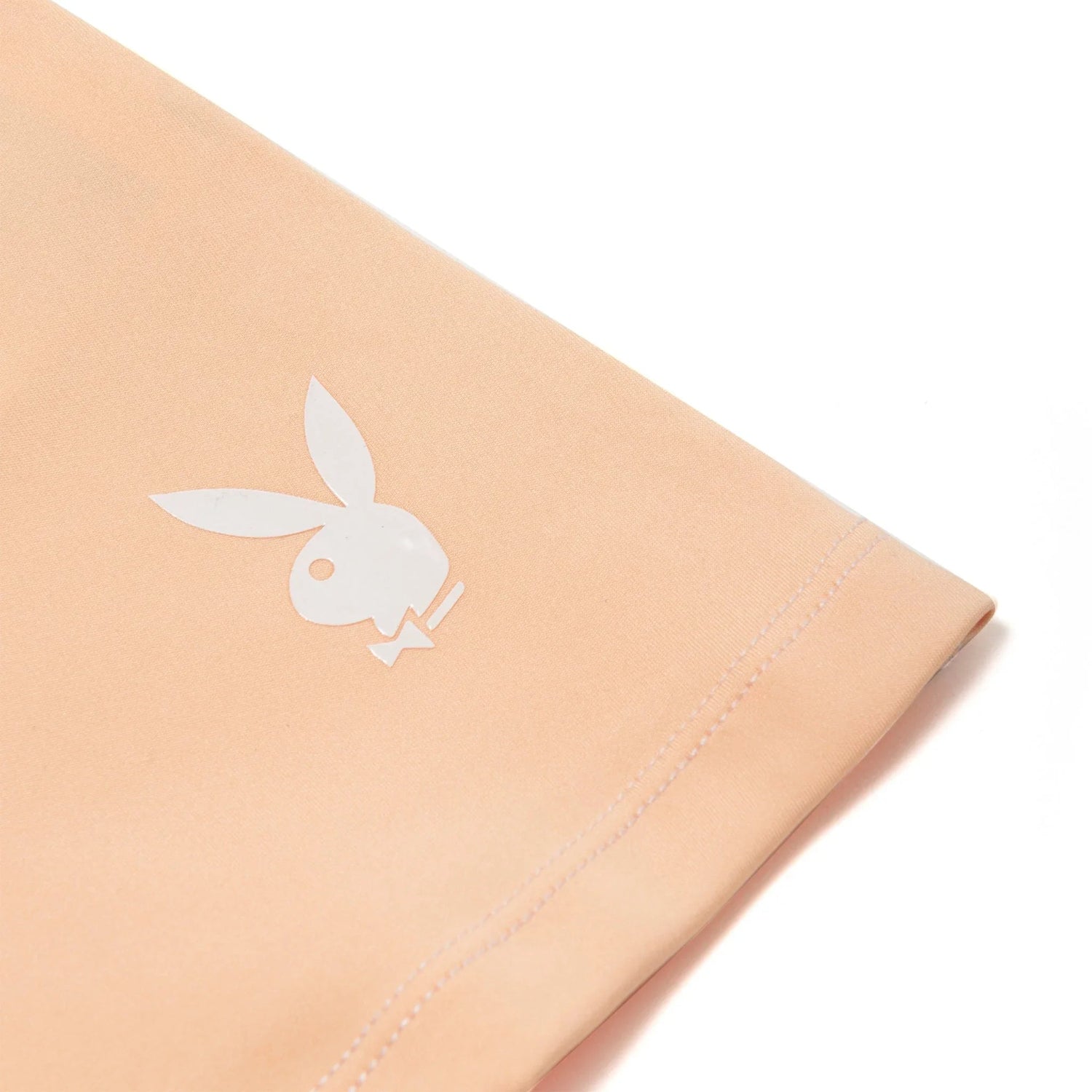 Peach women's active tee with white bunny logo and contrast stitching detail