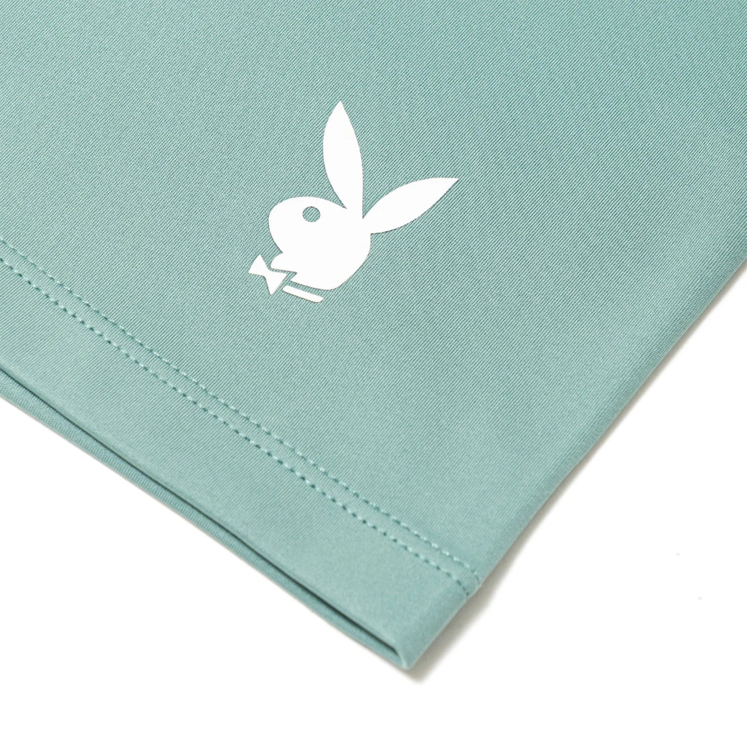 Close-up of teal women's active bike shorts with white bunny logo detail