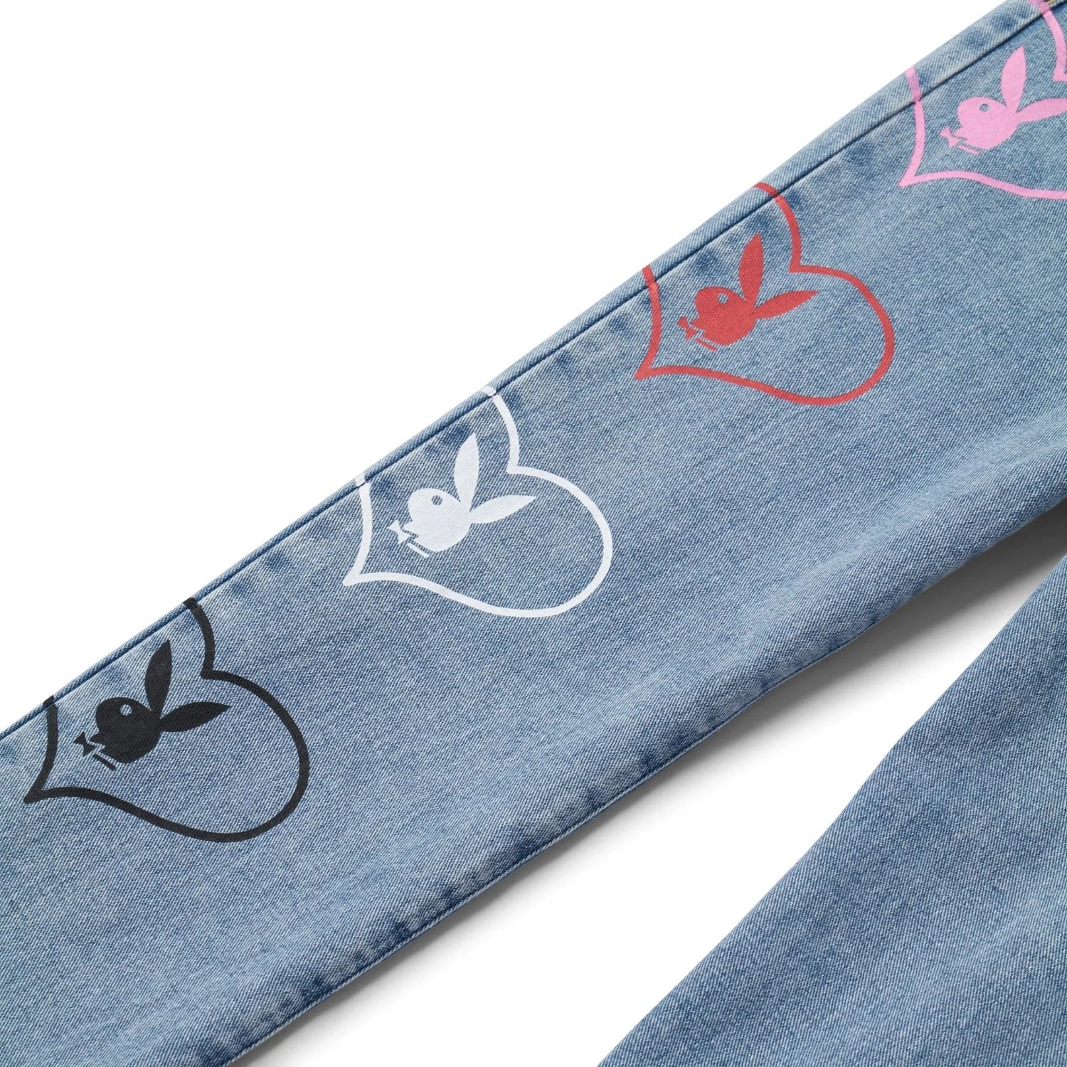 Light blue denim pants with colorful bunny and heart graphics on the leg