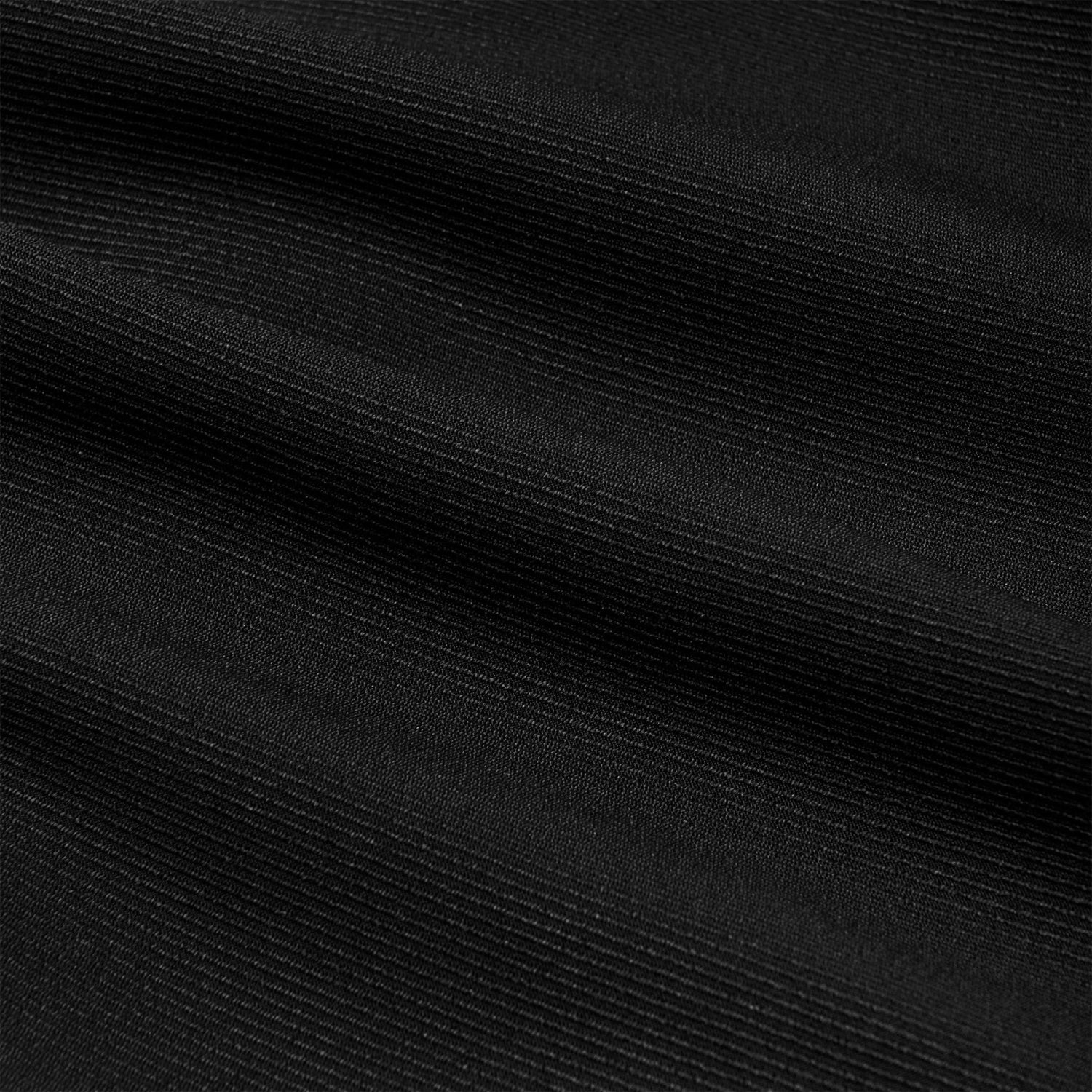 Close-up of black ribbed fabric texture, ideal for women’s boyfriend trousers.