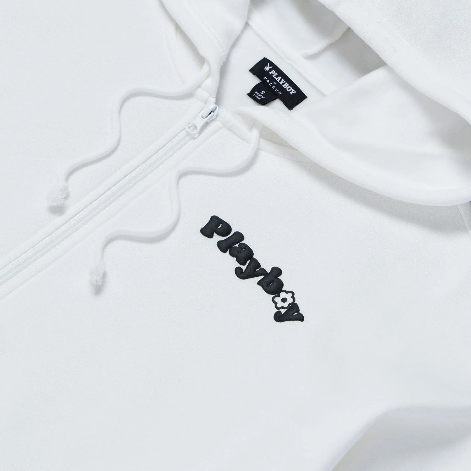 White oversized women's zip-up hoodie with black embroidered logo and drawstrings