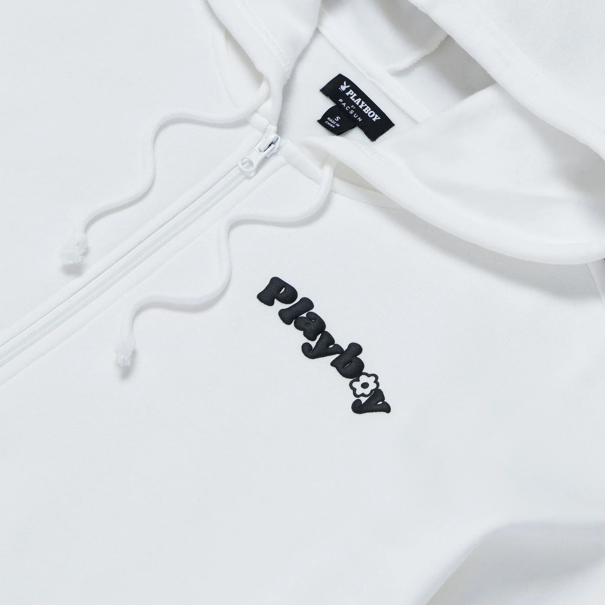 White oversized women's zip-up hoodie with black embroidered logo and drawstrings