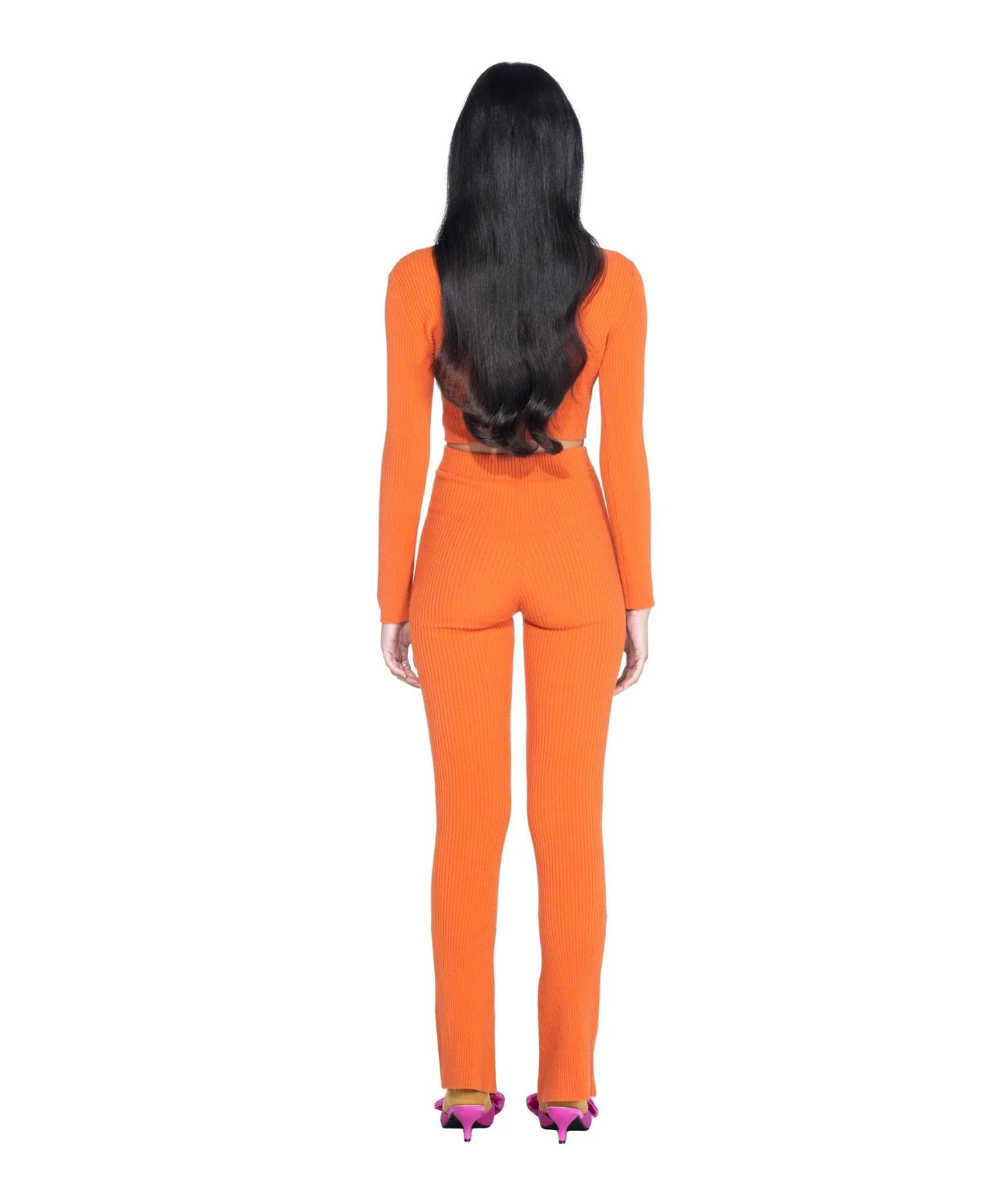 Woman wearing orange ribbed long sleeve crop top and matching pants, rear view