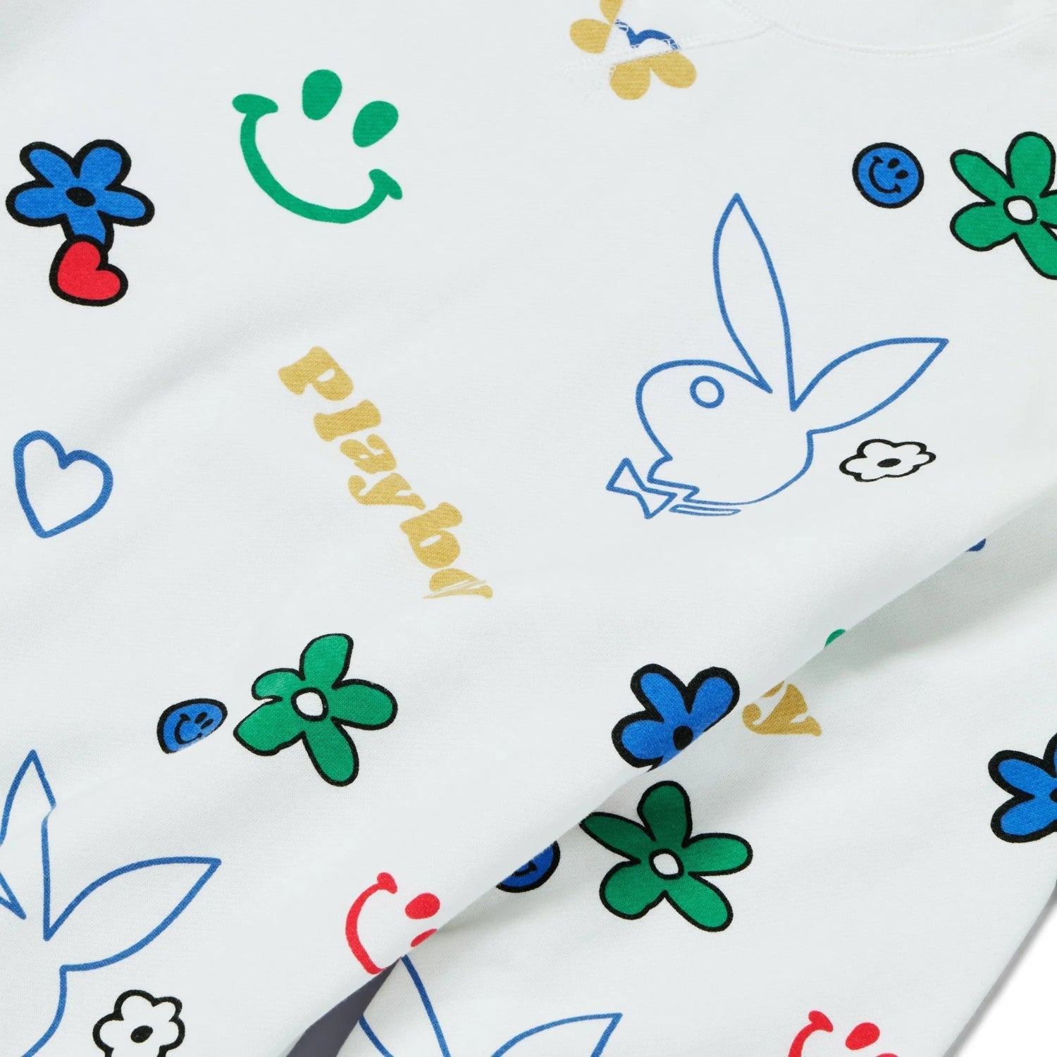 White crew neck sweatshirt with colorful doodle prints, flowers, smiley faces, hearts, and a bunny graphic.