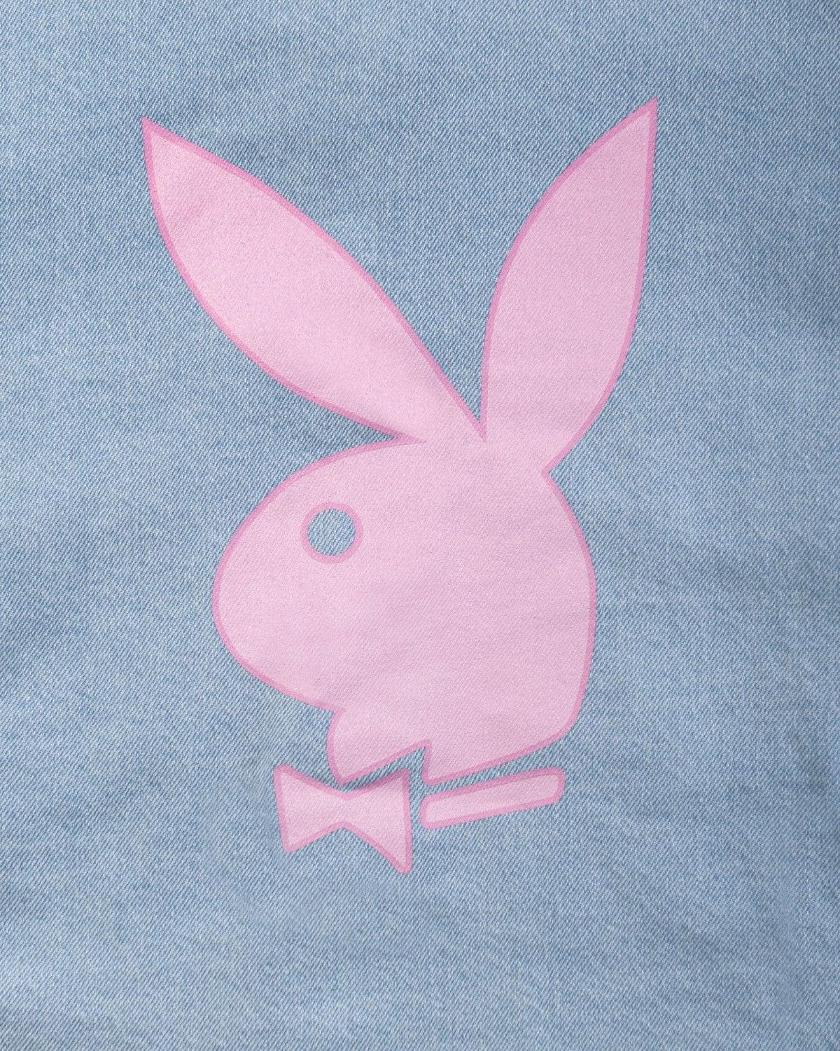 Pink bunny logo graphic on light blue denim fabric