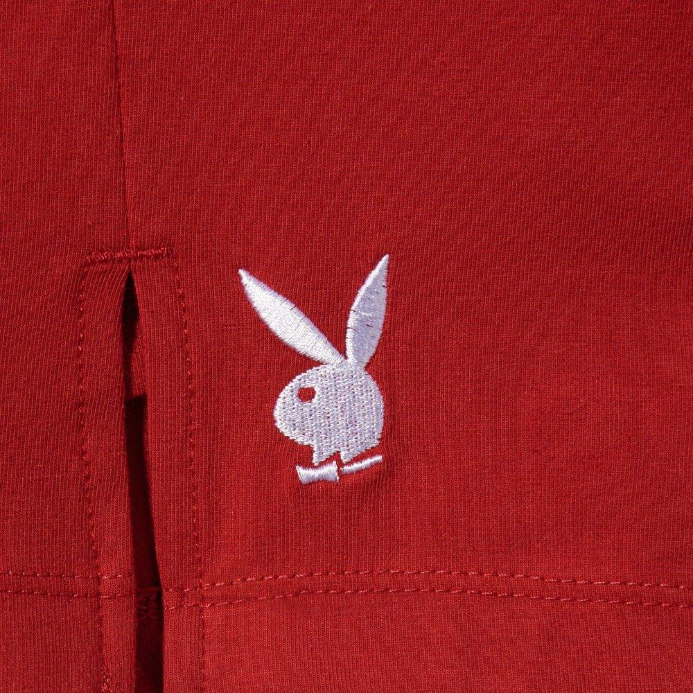 Close-up of red women's slit skirt with white bunny logo embroidery