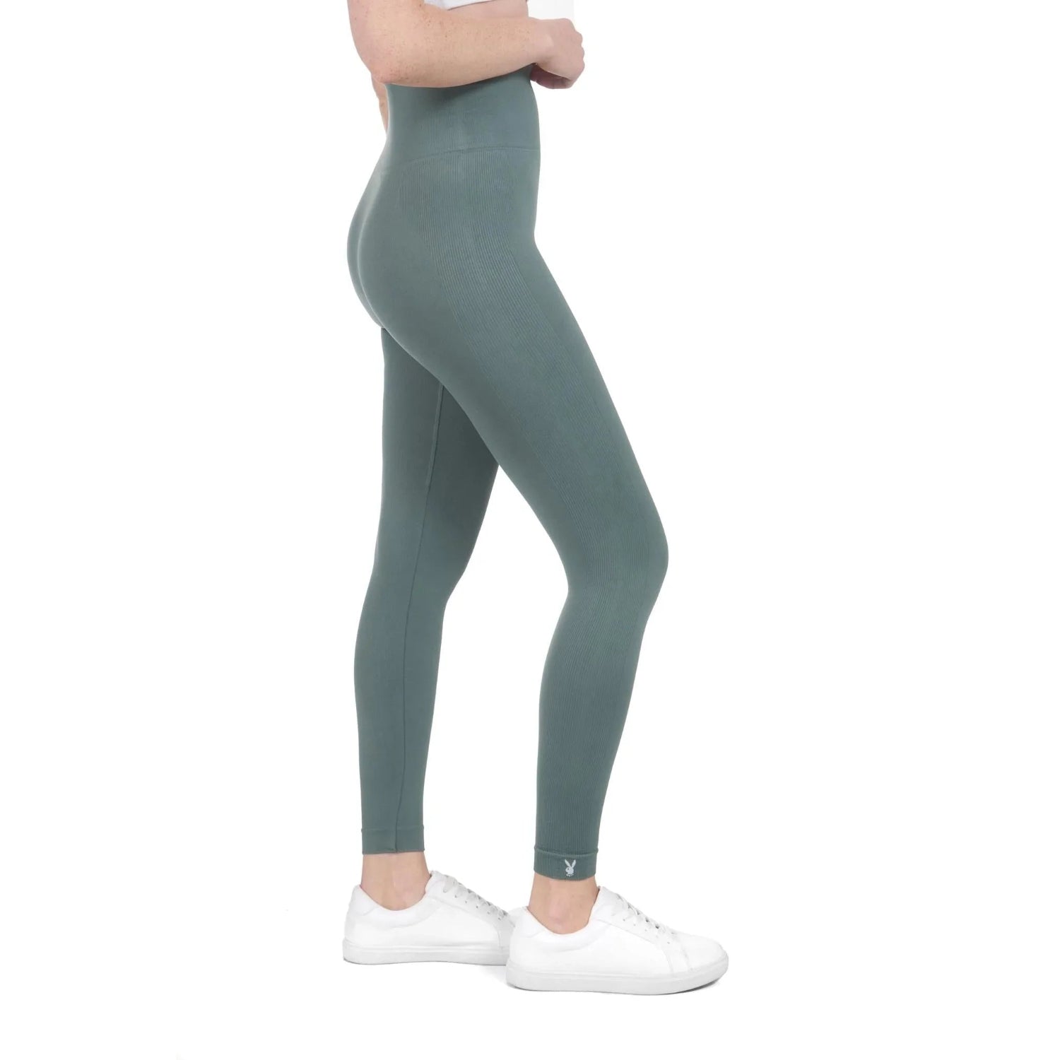 Woman wearing high-waisted sage green ribbed sport leggings with white sneakers