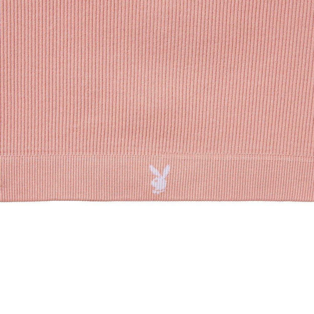 Pink ribbed women's sports bra with white bunny logo on the hem