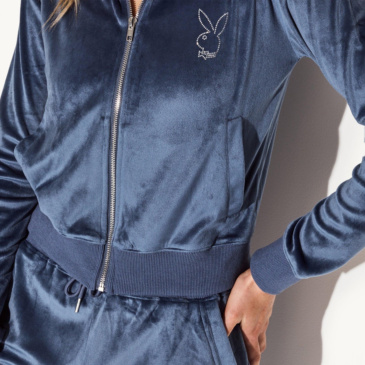 Women's blue velour zip-up jacket with rhinestone bunny logo on chest