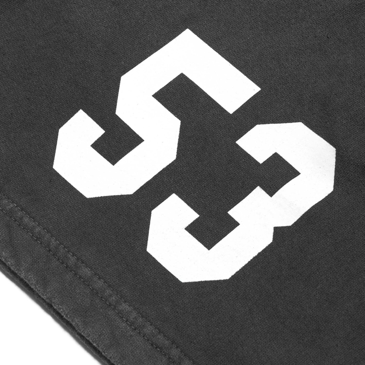 Close-up of black sweatshorts with bold white 53 graphic print