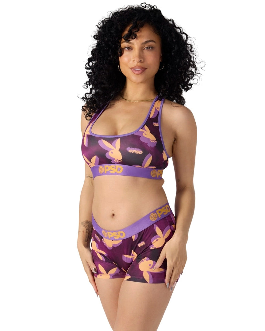 Woman wearing a purple sports bra and shorts set with 'BPSO' branding on a white background
